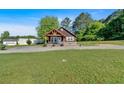 Charming one-story home with wood siding, covered porch, brick foundation, and grassy front yard at 3049 Highway 411 Ne, White, GA 30184