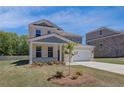 Beautifully landscaped two-story home featuring a two-car garage and lush lawn at 136 Dalston Cv, Stockbridge, GA 30281