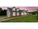 Charming two-story home with brick accents, dormer windows, and well-manicured lawn at 213 Whistle Way, Locust Grove, GA 30248