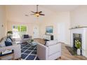Cozy living room with vaulted ceiling, fireplace, and stylish blue-toned furniture at 213 Whistle Way, Locust Grove, GA 30248
