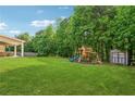 Spacious backyard featuring a playset and storage shed, offering ample space for outdoor activities at 2358 Well Springs Dr, Buford, GA 30519