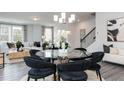 Bright dining area featuring a glass table, plush chairs, and views into the living room at 2719 Stream Valley Lane Nw Nw Cir, Atlanta, GA 30318