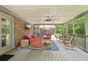 Relaxing back porch with comfortable seating, ceiling fan, and wooded views, ideal for outdoor living at 3235 Munsey Ct, Cumming, GA 30041