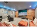 Entertainment basement with a large viewing screen, wood accent wall, and ambient lighting at 3235 Munsey Ct, Cumming, GA 30041
