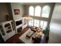Inviting living room with soaring ceilings, large windows, and a cozy fireplace at 3235 Munsey Ct, Cumming, GA 30041