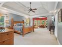 Spacious main bedroom suite with sitting area, tray ceilings, and ample natural light at 3235 Munsey Ct, Cumming, GA 30041