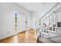 Bright foyer with hardwood floors, white trim and a staircase leading to the upper level at 5247 Hayden Farms Dr, Powder Springs, GA 30127
