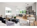 Bright open living space features a modern kitchen, light wood floors and lots of natural light at 1230 Mado Loop, Chattahoochee Hills, GA 30268