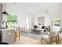 Bright open living space features a modern kitchen, light wood floors and lots of natural light at 1230 Mado Loop, Chattahoochee Hills, GA 30268