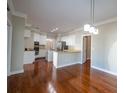 Bright open-concept kitchen with a breakfast bar, hardwood floors, and updated stainless steel appliances at 341 Little John Nw Dr, Lilburn, GA 30047