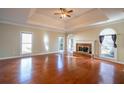 Bright living room featuring hardwood floors, a fireplace, and large windows at 341 Little John Nw Dr, Lilburn, GA 30047