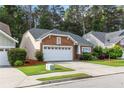 Attractive brick home with well-maintained lawn, two car garage, and lush landscaping, offering great curb appeal at 2319 Alnwick Dr, Duluth, GA 30096