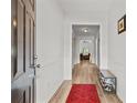 Inviting entryway with wood-look flooring, white wainscoting, and neutral paint, creating a bright and welcoming space at 2319 Alnwick Dr, Duluth, GA 30096