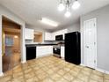 Bright eat-in kitchen with black appliances, white cabinets, and a neutral color scheme at 2430 Piering Dr, Lithonia, GA 30038