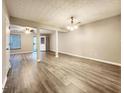 Spacious living room area featuring laminate flooring, neutral walls and natural light at 2430 Piering Dr, Lithonia, GA 30038