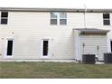 Well maintained backyard with green grass, AC units, and door access to the home at 2526 Piering Dr, Lithonia, GA 30038