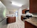 Efficient kitchen featuring modern stainless steel appliances and wood grain cabinets at 2526 Piering Dr, Lithonia, GA 30038