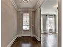 Inviting foyer with hardwood floors and view into the living room with bright natural light at 3910 Cameron Ct, Cumming, GA 30040