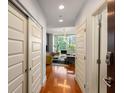 Hallway featuring hardwood floors leading into the living room with ample closet space on the left at 1080 Peachtree Ne St # 608, Atlanta, GA 30309