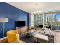 Living room with comfortable seating, modern lighting, and a beautiful view of the city at 1080 Peachtree Ne St # 608, Atlanta, GA 30309