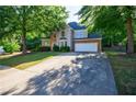 Charming two-story home with stone accents, manicured landscaping, and a long driveway at 2687 Mountain Oaks Ct, Powder Springs, GA 30127