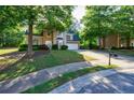Charming two-story home with stone accents, manicured landscaping, and a long driveway at 2687 Mountain Oaks Ct, Powder Springs, GA 30127