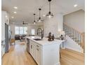 Modern kitchen open to the living area, featuring a spacious island, stainless steel appliances, and sleek design at 4814 Floydwood Ln, Mableton, GA 30126