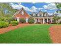 Beautiful home with large, well-manicured front lawn and mature trees at 328 Broadmoor Way, Mcdonough, GA 30253