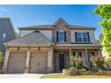 Charming brick and stone two-story home featuring a well-manicured lawn and a two-car garage at 4750 Sabino Bnd, Cumming, GA 30040