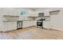 Bright kitchen featuring stainless steel appliances, white cabinets, granite countertops, and tile backsplash at 60 Wheeler Lake Path, Dallas, GA 30157