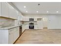 Modern kitchen with stainless appliances, granite counters, tile backsplash, and ample cabinet space at 60 Wheeler Lake Path, Dallas, GA 30157