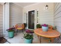 Inviting front porch featuring stylish seating and colorful potted plants at 2000 Suttles Sw Dr, Atlanta, GA 30331