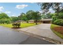 Lovely home on a spacious lot with a long driveway, mature trees, and well-kept landscaping at 4125 Hickory Dr, Powder Springs, GA 30127