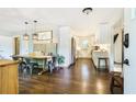 Stylish dining area with a long wooden table and adjacent, modern white kitchen at 4128 Morgan Rd, Tucker, GA 30084