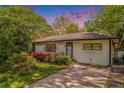 Charming single-story home with red flowers and a beautiful sky at sunset at 4128 Morgan Rd, Tucker, GA 30084