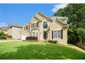 Attractive two-story home with a well-kept lawn, two-car garage, and welcoming front door at 5215 Tealing Ne Dr, Roswell, GA 30075