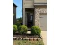 Inviting front entrance featuring brick facade, manicured landscaping, and covered porch at 11813 Lovejoy Crossing Blvd, Hampton, GA 30228