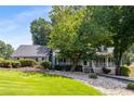 Landscaped front yard with a mature tree, offering shade and enhancing the home's curb appeal at 2790 Shiloh Way, Snellville, GA 30039