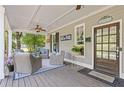Inviting covered front porch with comfortable wicker seating and ceiling fan at 527 Main St, Suwanee, GA 30024