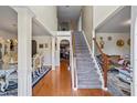 Grand foyer with hardwood floors, staircase, and views into formal dining and living areas at 7328 Vigo Dr, Lithonia, GA 30058