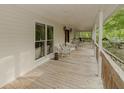 Spacious covered porch offering a peaceful spot with ample seating to enjoy the surrounding natural beauty at 8315 Nicholson Rd, Cumming, GA 30028