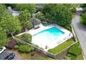 Aerial view of a large community pool with lounge chairs and a gazebo, surrounded by mature trees at 105 Olde Mill Ln, Norcross, GA 30093