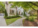 Charming home with stone pathway, manicured bushes, garden, and window boxes leading to the inviting front door at 1201 Beech Valley Ne Rd, Atlanta, GA 30306