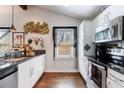 Modern kitchen featuring stainless steel appliances, granite countertops, and white cabinetry at 1314 Arkwright Se Pl, Atlanta, GA 30317