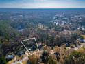 Aerial view showcasing the property's 0.68 acre lot size surrounded by lush greenery and neighborhood homes at 1355 Compton Woods Dr, Loganville, GA 30052