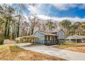 Charming two-story home featuring a covered carport and a welcoming front porch at 1355 Compton Woods Dr, Loganville, GA 30052