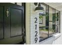 Close up detail of front door with address numbers, modern black trim and brick, and a sidelight window at 2129 Arlington Ne Ave, Atlanta, GA 30324