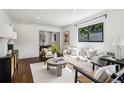 Bright living room featuring hardwood floors, recessed lighting, and neutral furniture, flowing into dining area at 2129 Arlington Ne Ave, Atlanta, GA 30324