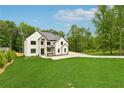 This two-story home features a landscaped front yard and a dark roof, complemented by a spacious concrete driveway at 2977 N Bogan Rd, Buford, GA 30519