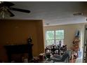 View of the open-concept living room featuring a large window and fireplace at 4752 Browns Mill Ferry Rd, Lithonia, GA 30038